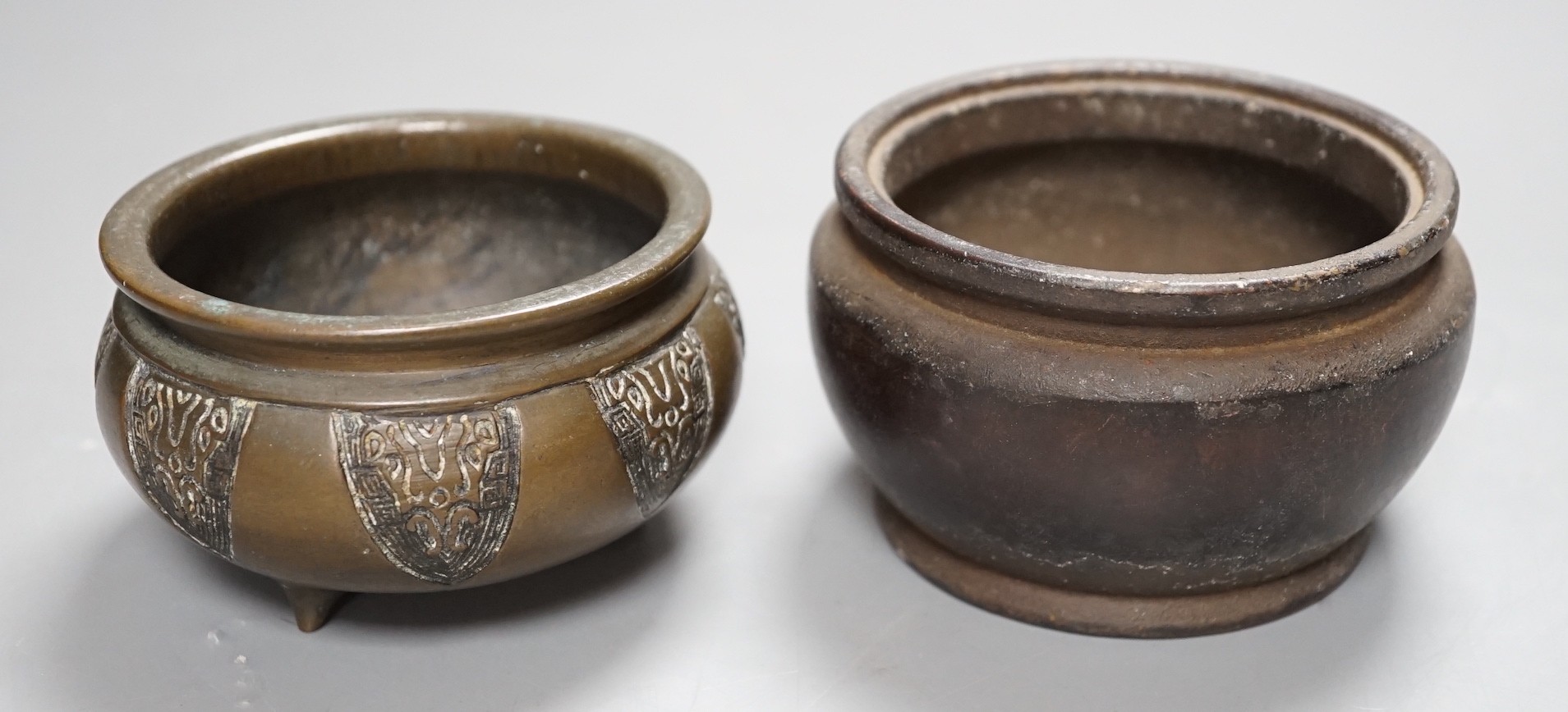 Two Chinese bronze censers, one inscribed, tallest 6cm